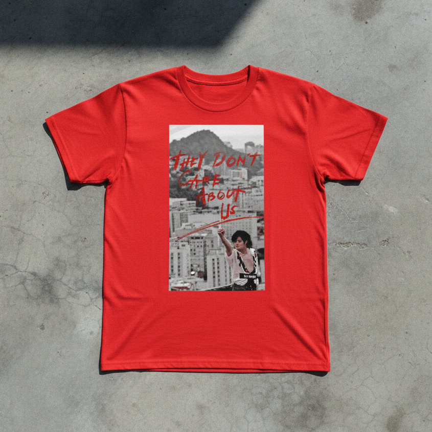 They Don't Care About Us Tee — Grey Concrete Flat Lay | DARTFYT®